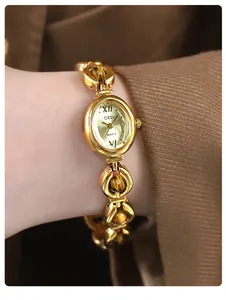 Close-up of GEDI vintage gold bracelet watch with tiger's eye stone beads