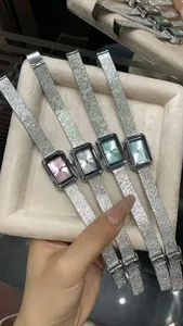 Close-up detail of GEDI rectangular quartz watches with elegant pastel dials and silver bands