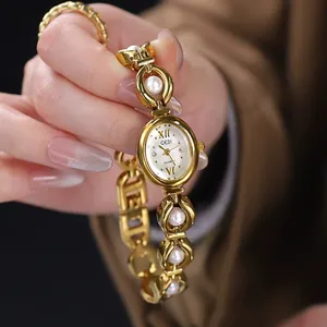 Elegant GEDI gold bracelet watch for women featuring pearl accents and white oval dial