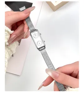 Close-up detail of vintage rectangular dual-dial watch with a silver mesh steel strap