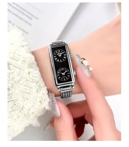 Detailed macro view of a vintage dual-time quartz watch with a silver mesh strap