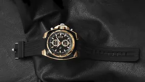 Close-up view of V6 men's fashion watch with black silicone strap and gold accents