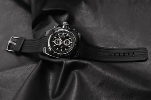 Detailed macro view of the V6 men's sports watch with black silicone strap on leather.