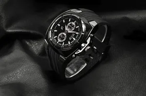Detail of V6 men's fashion watch with silicone strap on black textured leather backdrop