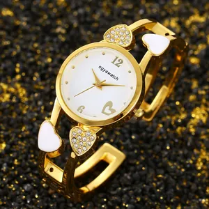 Primo piano di un elegante orologio a bracciale dorato con cuori in cristallo