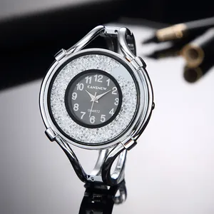Close-up of elegant silver bracelet watch for women with floating diamonds and black dial