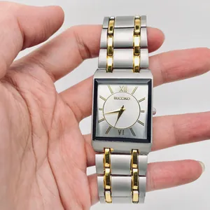 Detail view of square quartz watch with two-tone silver and gold steel band