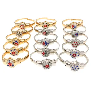 Detailed shot of stylish ladies flip-top bangle watches with colorful rhinestone patterns