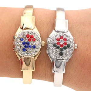 Close-up of elegant gold and silver bangle watches with vibrant rhinestone flip covers