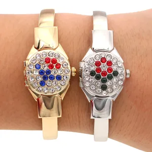 Detail of elegant gold and silver ladies bangle watches with sparkling rhinestone flip covers