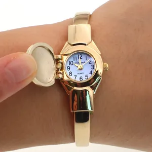 Close-up of gold bangle watch for women with functional flip-top cover design