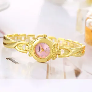 Montre à quartz élégante pour femmes avec bracelet doré et cadran rose rond.
