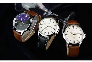 Tre orologi business Yazole minimalisti con cinturini in pelle e grandi quadranti su sfondo nero