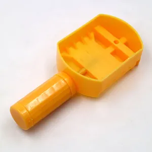 Top-down detail of a yellow plastic watch band link remover tool for strap adjustment