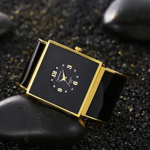 Primo piano di elegante orologio a bracciale nero quadrato da donna con finiture oro