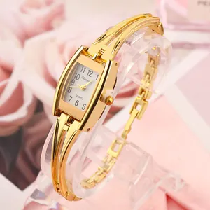 Detailed close-up showing the vintage golden bracelet watch and rectangular dial