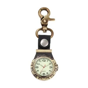 Detail view of vintage bronze quartz nurse watch with luminous dial and swivel clip