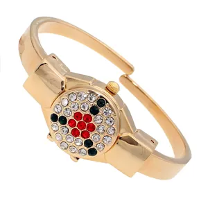 Gold-tone ladies bangle watch with flip cover and colorful rhinestone floral detail