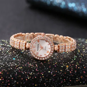 Dettaglio di orologio da donna in oro rosa di lusso con lunetta e cinturino in strass.