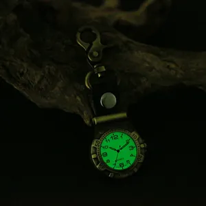 Close-up detail of the luminous green glowing dial on a vintage punk quartz climbing watch