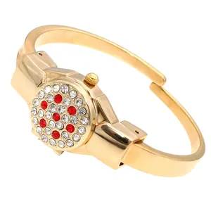 Detailed view of golden rhinestone bracelet watch with decorative flip-up lid cover.