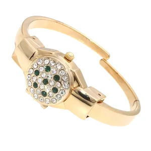 Close-up of elegant ladies' gold bracelet watch featuring a rhinestone flip cover