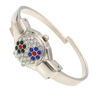Detailed macro view of the colorful rhinestone flower pattern on women's silver bangle watch
