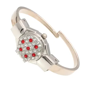 Close-up of elegant ladies' bangle watch featuring red and white rhinestone flip cover