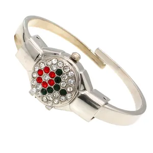 Detail view of the floral rhinestone encrusted flip cover on a silver ladies bangle watch