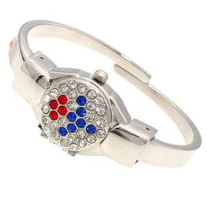 Close-up of a silver ladies bangle watch with a red and blue rhinestone flip cover