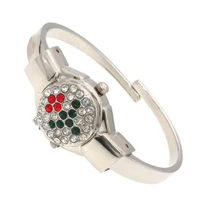 Detailed view of rhinestone-encrusted flip cover on silver ladies bangle watch