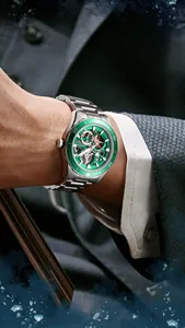 Close-up of Mark Fairwhale skeleton automatic watch with green bezel on wrist