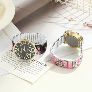 Detail view of women's floral print elastic band watch with large numerals and back case.
