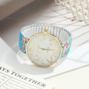 Close-up of floral print elastic band watch with large gold numbers and white dial