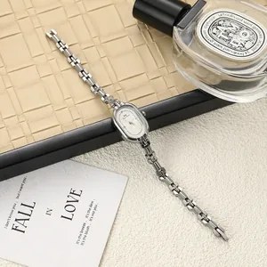 Detailed close-up of vintage oval silver bracelet watch for women with elegant metal strap
