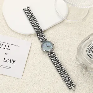 Detailed view of a vintage elegant women's chain watch with a blue pearl dial