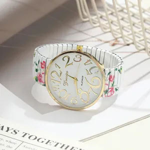 Close-up of elegant floral rose print stretch band watch with large golden numerals