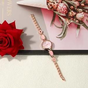 Detailed macro view of the elegant rose gold irregular bracelet watch with pink enamel