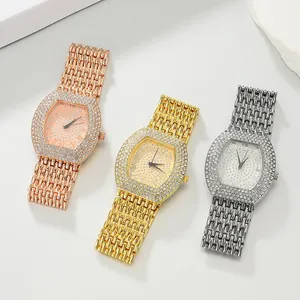 Close-up of elegant rhinestone-encrusted tonneau watches in gold, silver and rose gold.