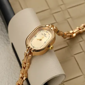 Retro oval gold watch with Blue Sense logo shown on elegant beige leather stand