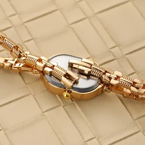 Detailed view of a retro gold oval ladies watch with a stylish link bracelet.