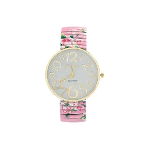 Close-up of pink floral elastic band watch with large golden numerals on dial