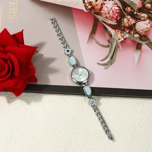Elegant ladies irregular bracelet watch with light blue enamel inlay and quartz movement.