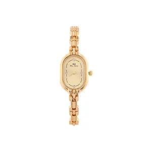 Detailed close-up of a vintage oval gold watch featuring a chic bracelet style strap