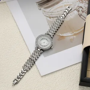 Detailed top-down view of a silver rhinestone watch with floating crystals on the dial.