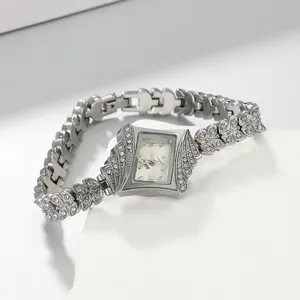 Detailed close-up of an elegant rhinestone-encrusted bracelet watch with a silver dial