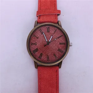 Macro view of fashion quartz watch with orange denim texture strap and bronze case