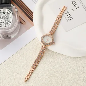 Detailed view of a rose gold flower-shaped watch with a rhinestone-studded bracelet