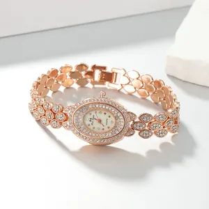 Close-up of rose gold oval ladies' watch featuring sparkling rhinestone embellishments