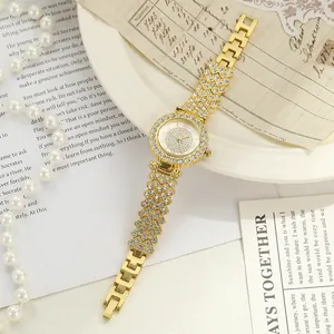 Elegant gold women's watch featuring a rhinestone dial and strap segments detail